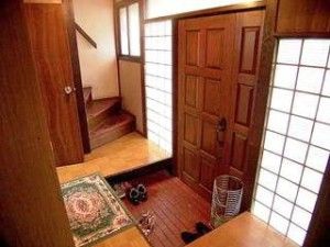 the interior of a house with wood floors and wooden doors, including an entry way