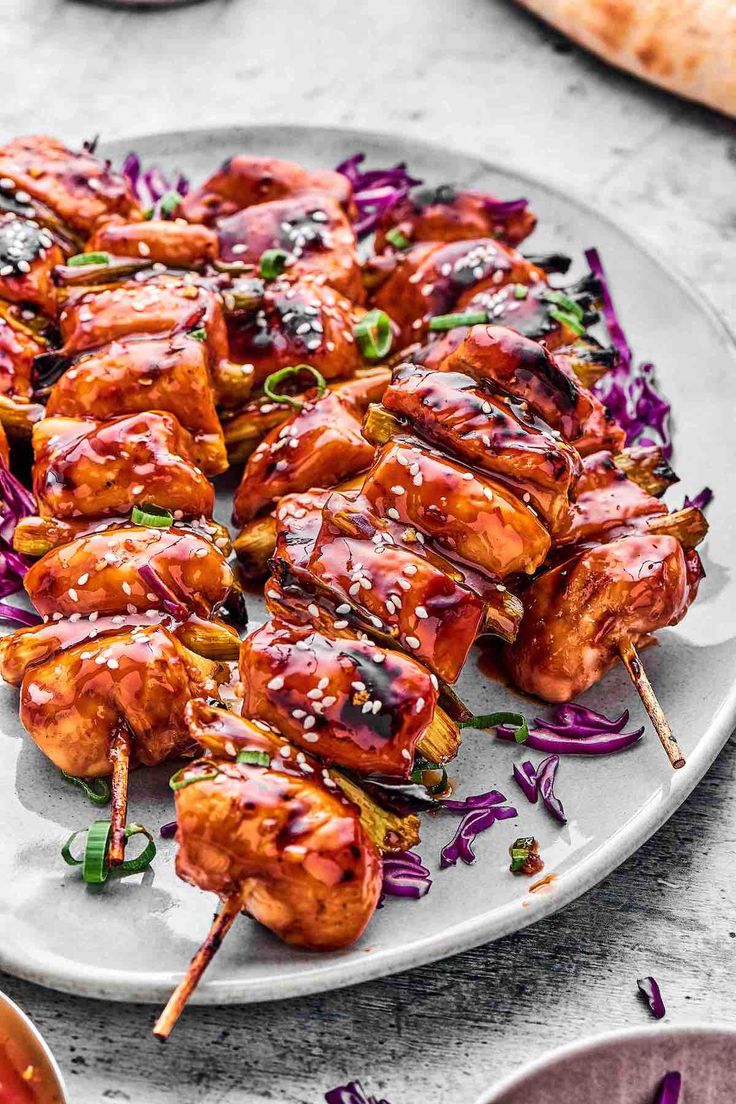 chicken skewers covered in bbq sauce on a plate