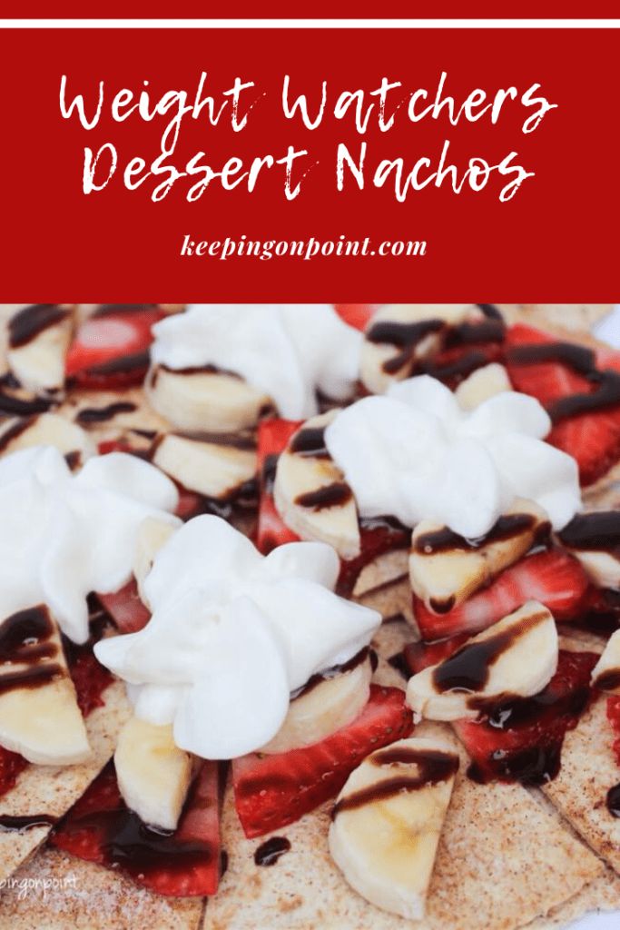 a pizza topped with sliced bananas and strawberries next to whipped cream on top of it