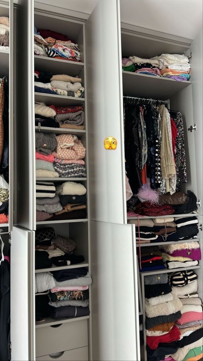 the closet is full of clothes and other things to wear in it's storage area