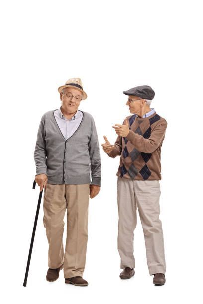 two older men standing next to each other with their hands together and one holding a cane