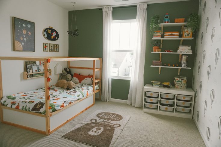 a child's bedroom with green walls and white carpet