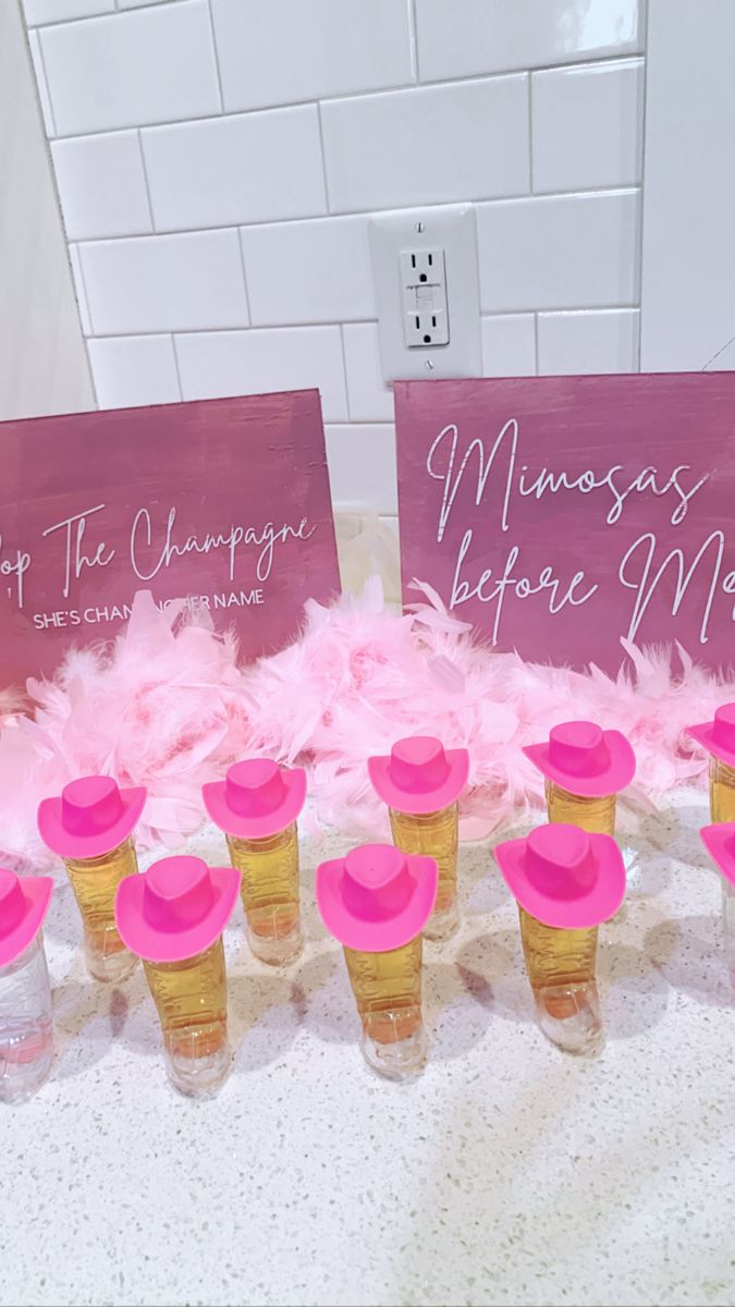 pink and gold cupcakes are arranged on a table with signs that read, happy the cheepy marriage