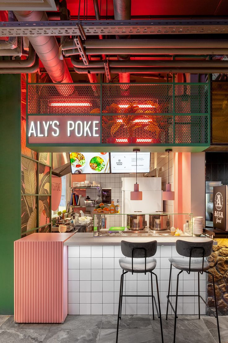 an aly's poke restaurant with three stools in front of the counter