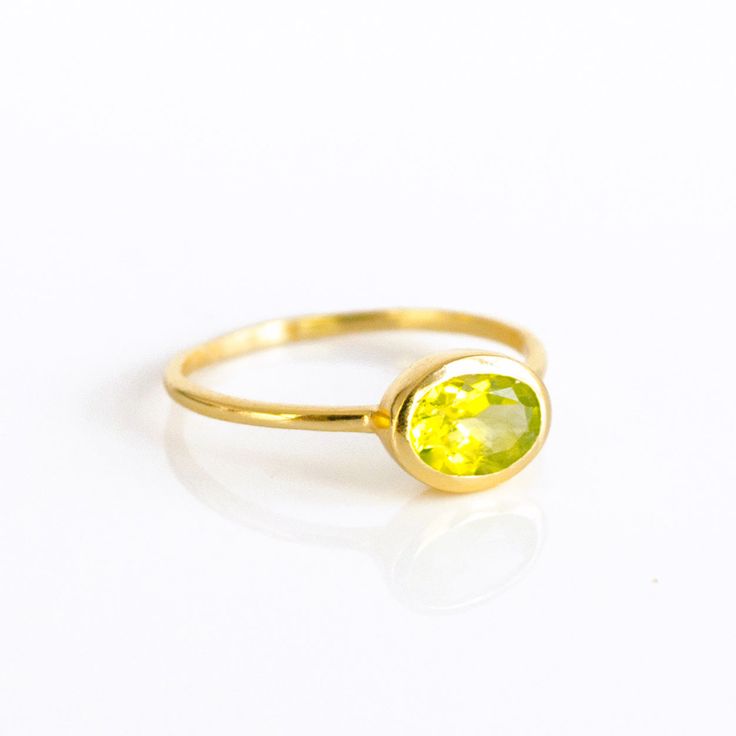 You'll fall in love with the stunning green color of this Peridot Quartz ring. This is a perfectly sized oval to compliment any collection. Popular as a birthday gift for those August babes and Peridot lovers alike. This stone is beautifully faceted and bezel set in a 925 sterling silver band or plated with 18k vermeil gold. Gemstone is approximately 8 x 6mm.Band has 925 stamp on inside.Please note that each ring is handmade and there may be some slight variations from listing photo.Available in Oval Birthstone Ring Gift, Oval Green Gemstone Birthstone Ring, Lime Green Gemstone Birthstone Ring As Gift, Lime Green Gemstone Birthstone Ring For Gift, Lime Green Birthstone Ring As A Gift, Emerald Oval Cabochon Ring Gift, Lime Green Oval Jewelry For May Birthstone, Oval Lime Green Ring For Gift, Oval Lime Green Rings For Anniversary