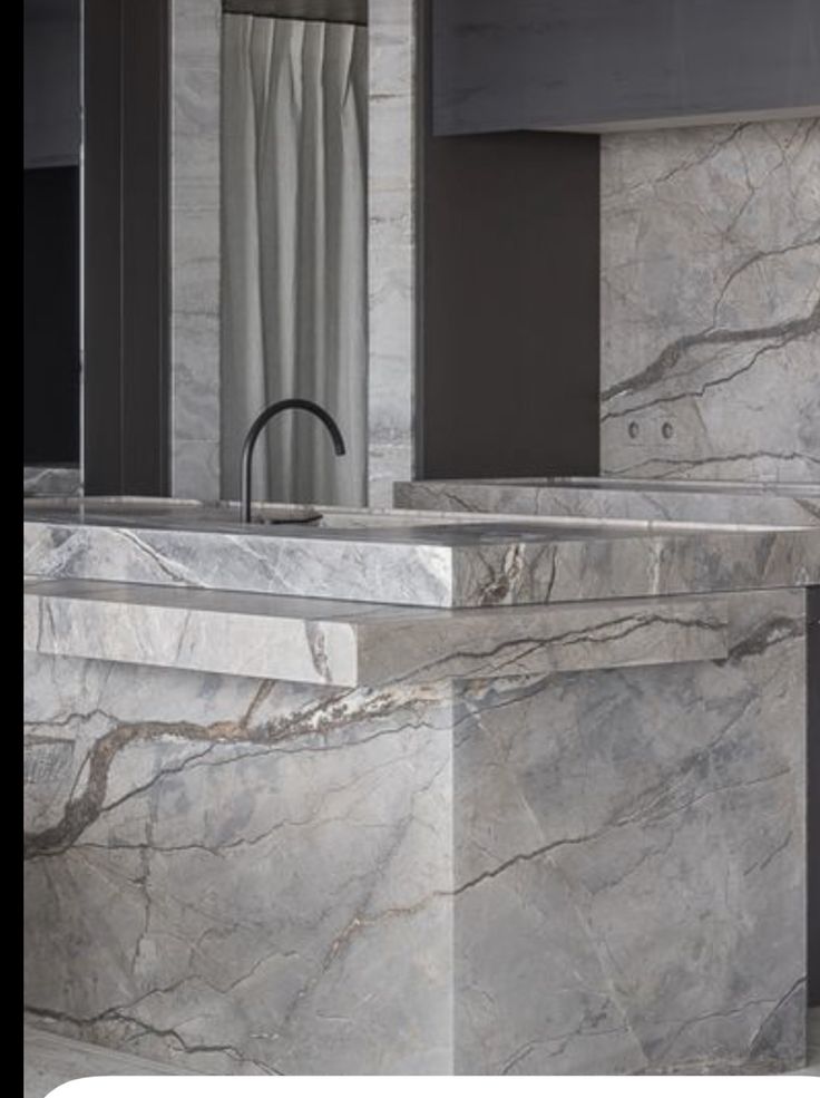 a bathroom with marble counter tops and sinks