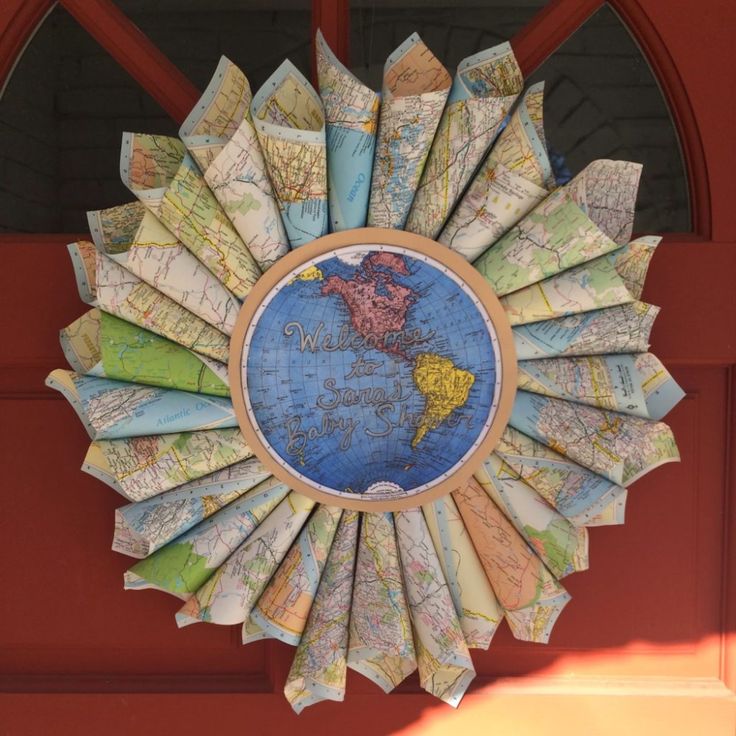 a sunburst made out of maps is hanging on the door