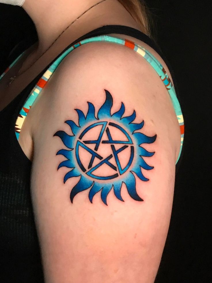 a woman's arm with a tattoo on it and a pentagramil in the middle