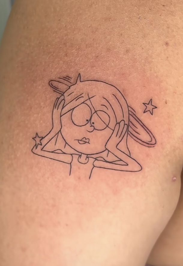 a woman's thigh with a cartoon character tattoo on her left side ribcage