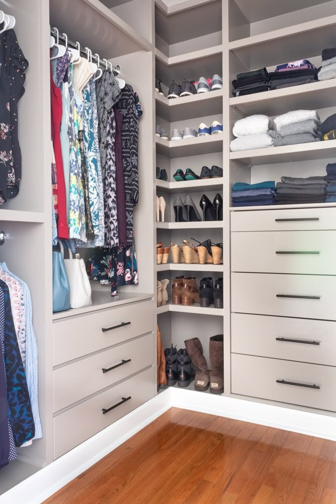 a walk in closet filled with lots of drawers and clothes on top of shelves next to a hard wood floor