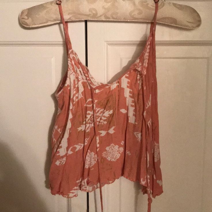 Beachy Spaghetti Strap Top. It Is A Coral Crop Top, Perfect For The Summer With Cute Decides And Beaded Ties. Never Worn And In Great Condition. V-neck Tie Back Tank Top For Beach, Summer V-neck Crop Top For Vacation, Summer V-neck Beach Crop Top, Triangle Top For Summer Day Out, Casual V-neck Crop Top For Beach, Summer Triangle Top With Tie Back, Triangle Top With Tie Back For Summer, Tie Back Triangle Top For Summer, Beach Tops With Adjustable Straps Triangle Top