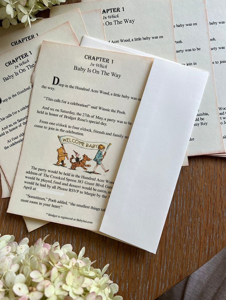 some papers are laying on a table with flowers