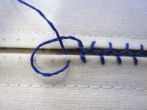 a close up of a piece of cloth with blue thread