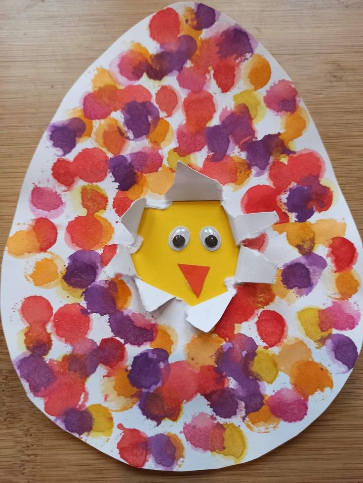 a paper plate with an egg shaped like a chick