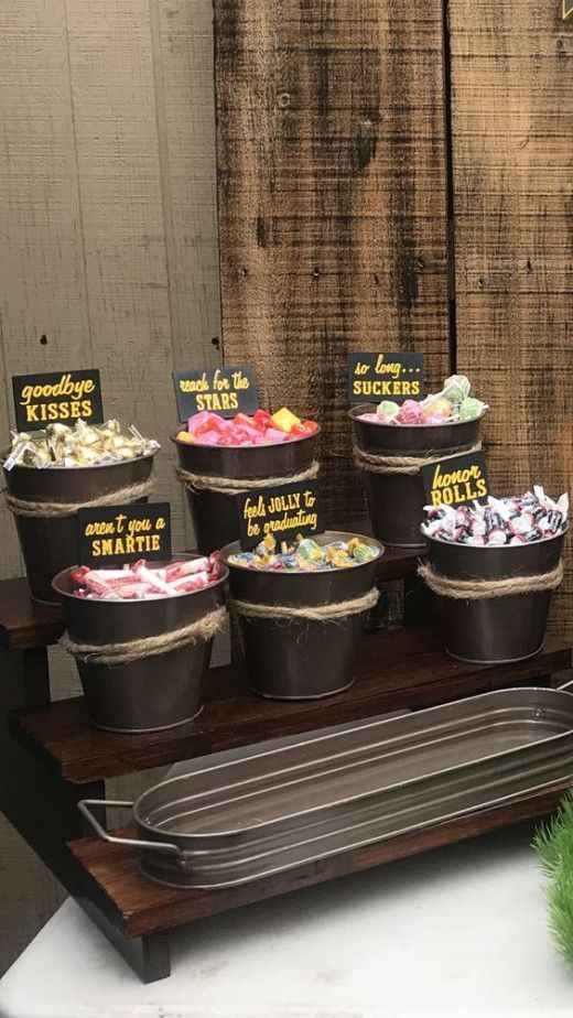 an assortment of desserts displayed in buckets on a table