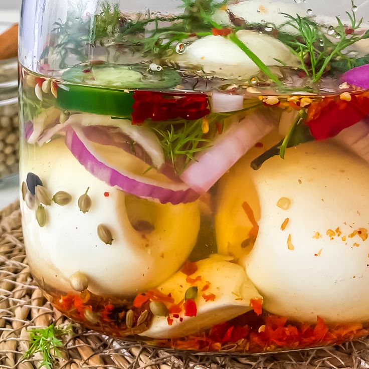 a glass jar filled with food sitting on top of a table