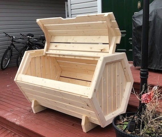 a wooden bench sitting on top of a porch next to a potted planter