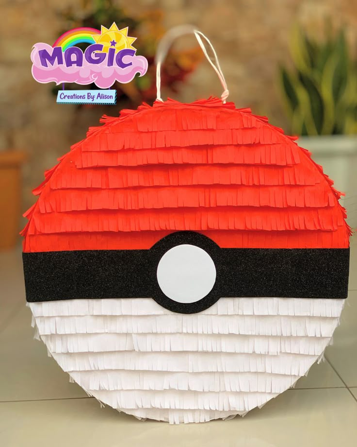 a close up of a paper ball with a pokeball on it's side