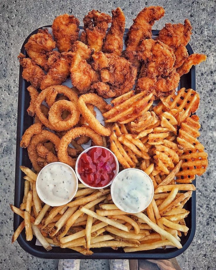 chicken wings, fries and dips on a tray