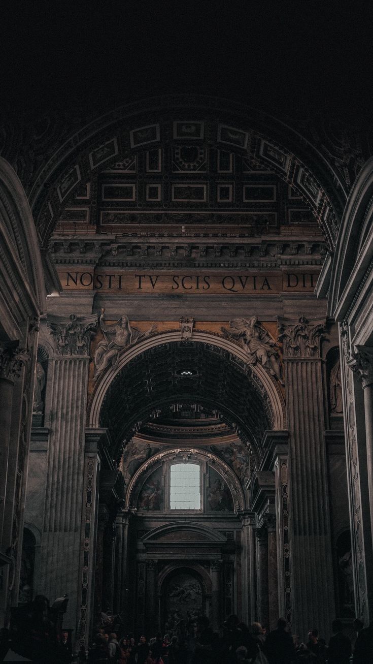 the inside of an old building with columns and arches