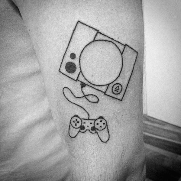 a black and white photo of a man's arm with a video game controller tattoo on it