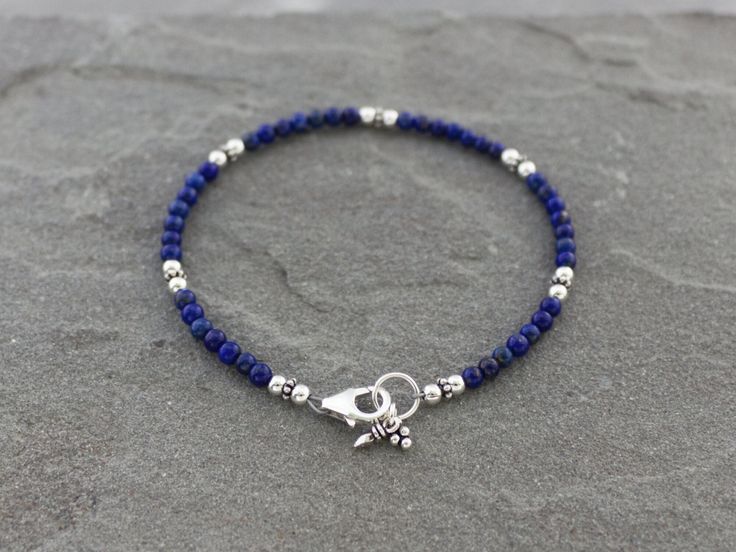 3mm Lapis Lazuli beads are paired with sterling silver accents in this dainty bracelet. These stones are all natural bright blue AAA Lapis from Afghanistan. Finished with a secure sterling silver lobster clasp and coordinating sterling silver charms. Perfect to wear by itself or with other bracelets for a stacked look.  Sterling silver is .925 pure silver. ✧ Message me if you would like this bracelet in a different size. See more Lapis Lazuli jewelry here: https://www.etsy.com/shop/LindseySilber Lapis Jewelry, Lapis Lazuli Bracelet, Black Onyx Bracelet, Lapis Lazuli Jewelry, Lapis Lazuli Beads, Onyx Bracelet, Dainty Bracelets, Silver Accents, Sterling Silver Charm