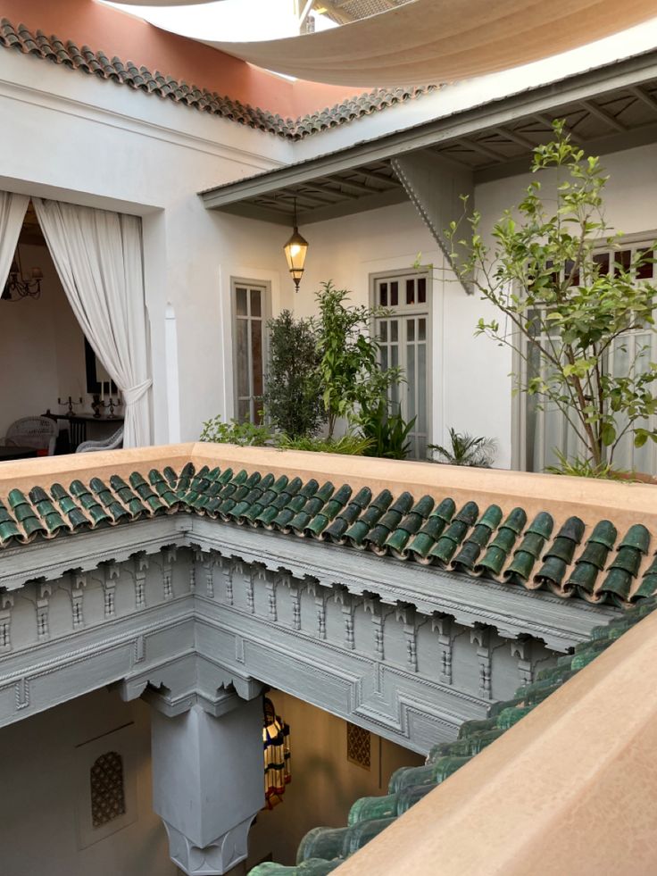 the inside of a building with many green chairs on it's sides and windows