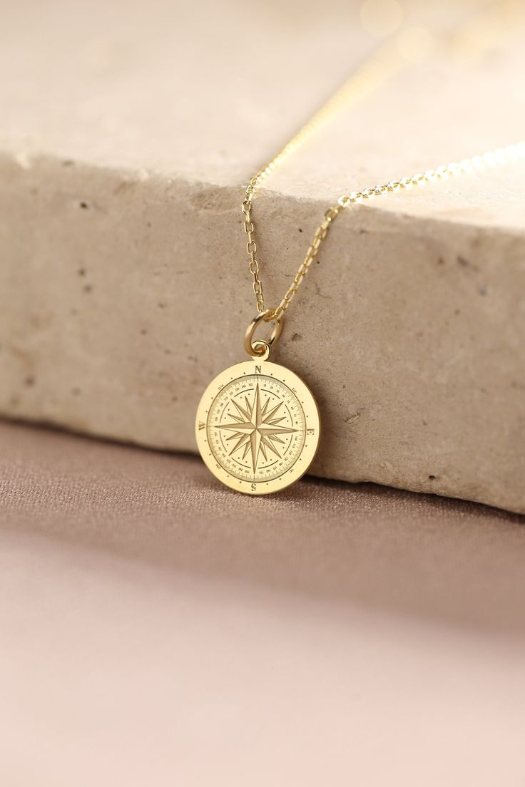 Gold Compass Pendant - Compass Gold Necklace ● Material of pendant: Solid Gold 14k ( REAL GOLD ) ● Metal Stamp: 14k ( REAL GOLD ) ● The pendant is available in 5 sizes: - 12,7 mm / 0.5 inches (Diameter) - 14,0 mm / 0,55 inches ( Diameter ) In the photos - 15,3 mm / 0.6 inches ( Diameter ) - 16,5 mm / 0,65 inches ( Diameter ) - 19,1 mm / 0,75 inches ( Diameter ) ( In the photos the size is 14mm / 0.55 inches Diameter ) ( Jump Ring inner diameter: 4 mm ) ● Material of chain: Solid gold 14k ( REAL Gold Round Pendant Necklace For Travel, Personalized Gold Jewelry For Travel, Gold Necklace With Round Pendant For Travel, Gold Compass Design Necklace For Travel, Gold Engraved Jewelry For Travel, Engraved Medallion Necklace For Travel, Personalized Gold Necklace For Travel, Travel Engraved Gold Jewelry, Personalized Pendant Necklaces For Travel