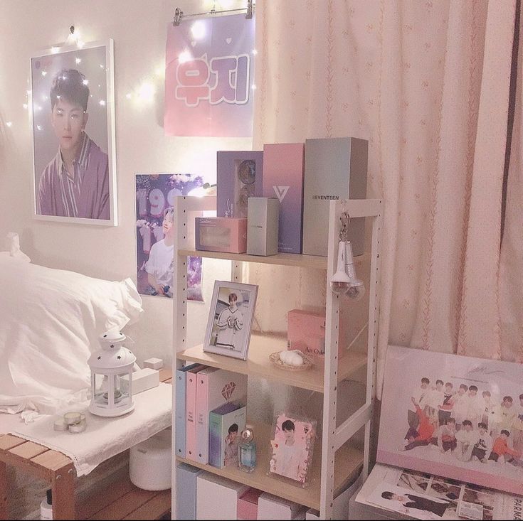 a bed room with a book shelf and pictures on the wall