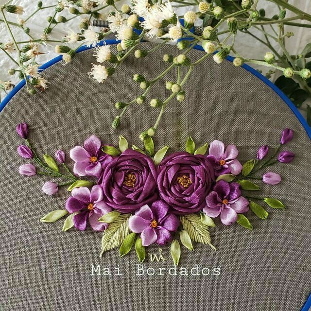 a close up of a embroidery on a hoop with flowers