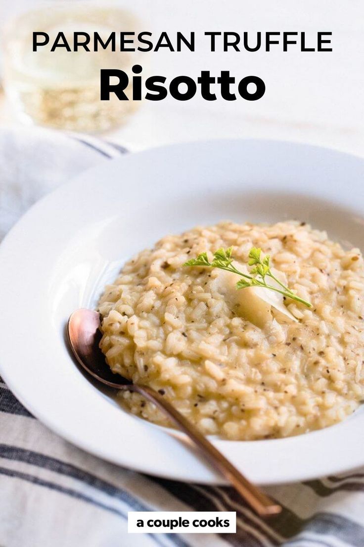 a white plate topped with risotto next to a fork