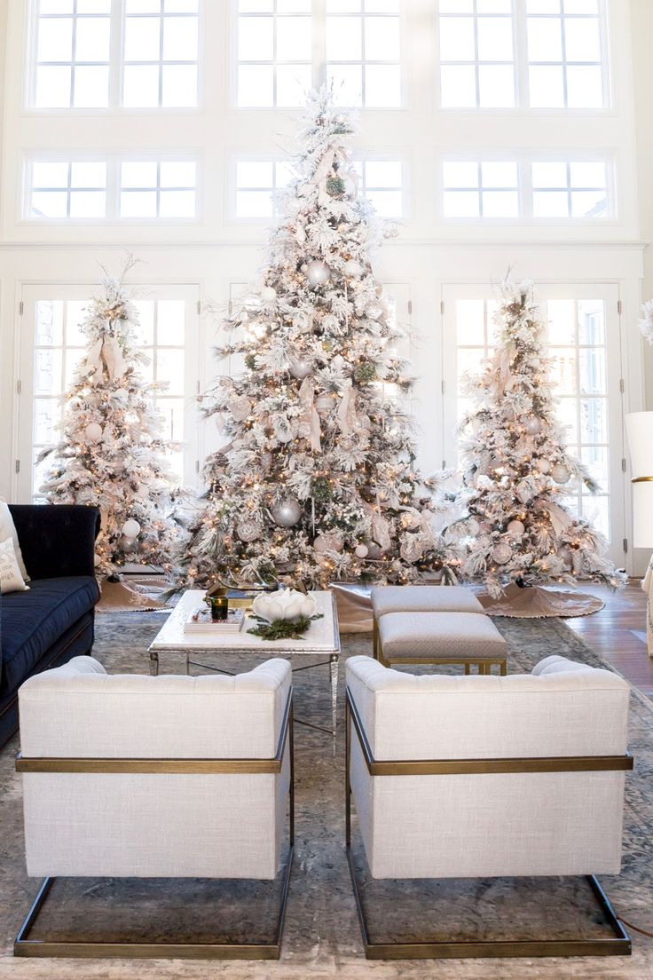 a living room filled with furniture and a christmas tree in the middle of the room