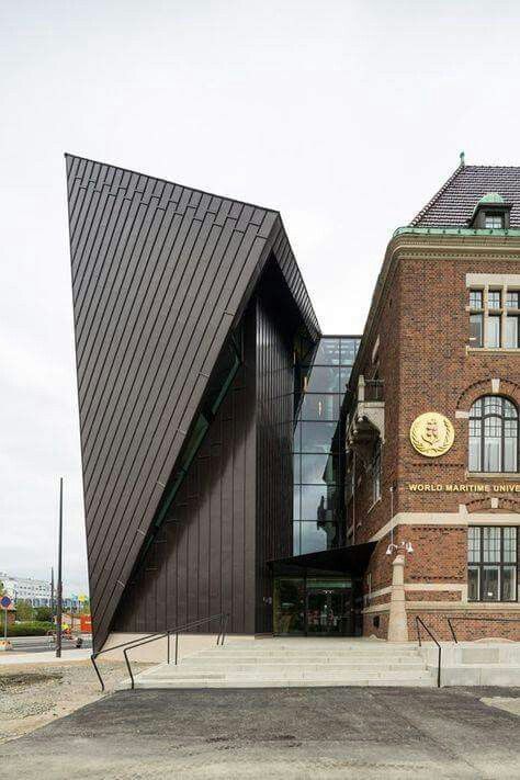 an old brick building with two triangular shaped windows