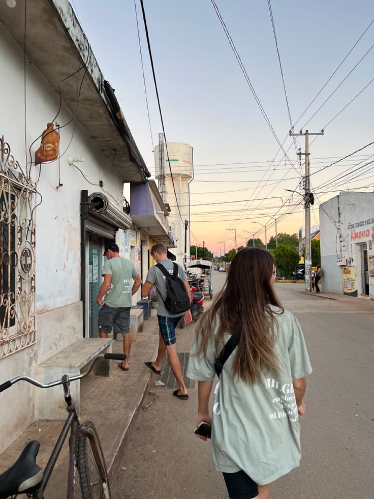 people walking down the street in front of a building