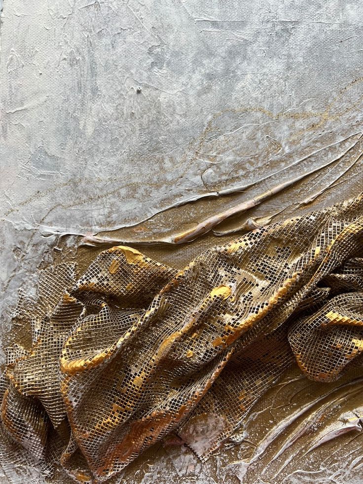 a close up of a snake skin on a metal surface with dirt and water around it