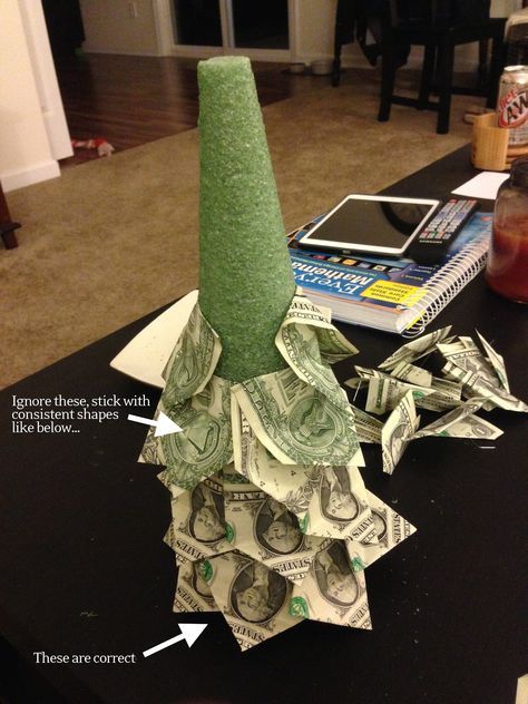 a vase made out of money sitting on top of a table