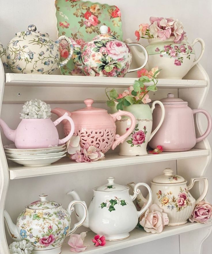 a shelf filled with lots of different kinds of teapots and cups on top of each other