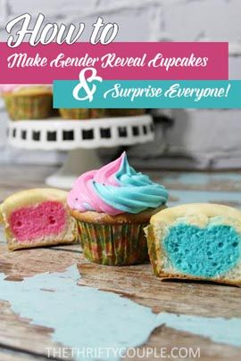 cupcakes with blue and pink frosting sitting on top of a wooden table