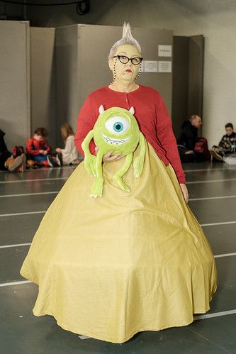 a woman in a costume is standing on the floor with a stuffed toy inside of her