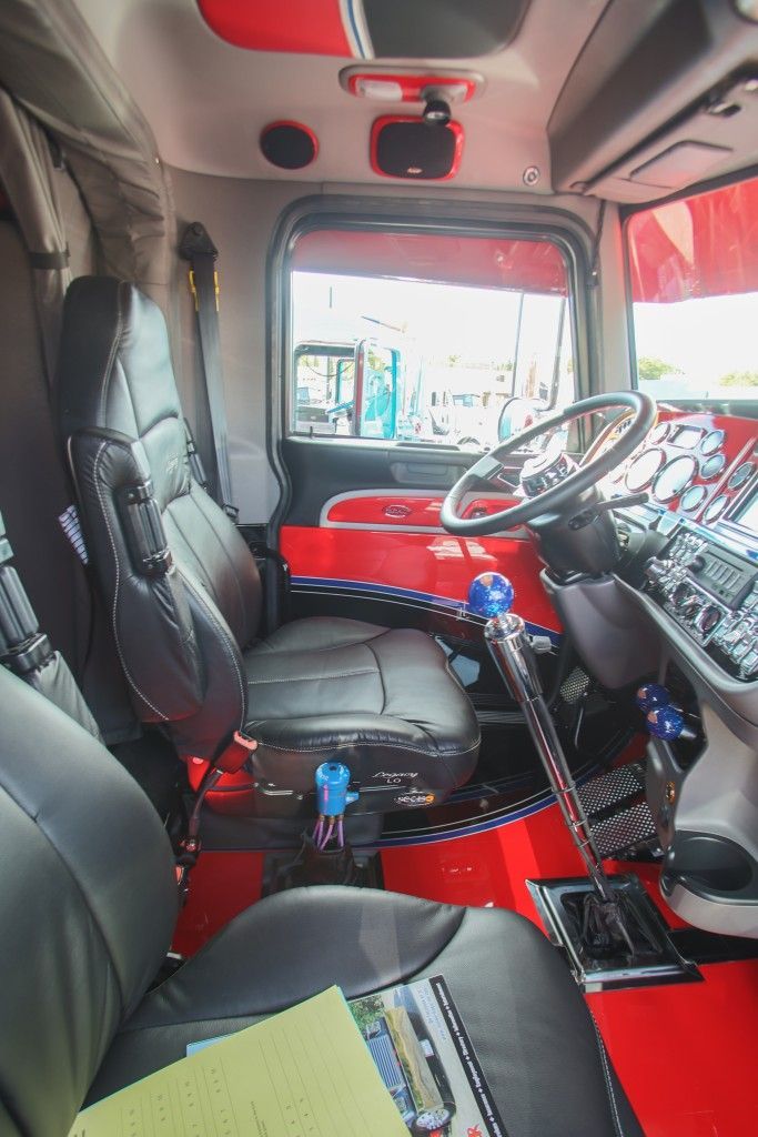 the interior of a red and black truck