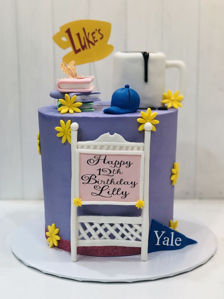 a birthday cake with a sign and flowers on it