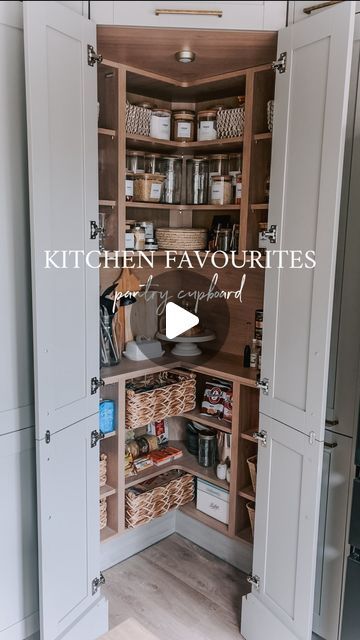 an open kitchen cupboard with baskets in it