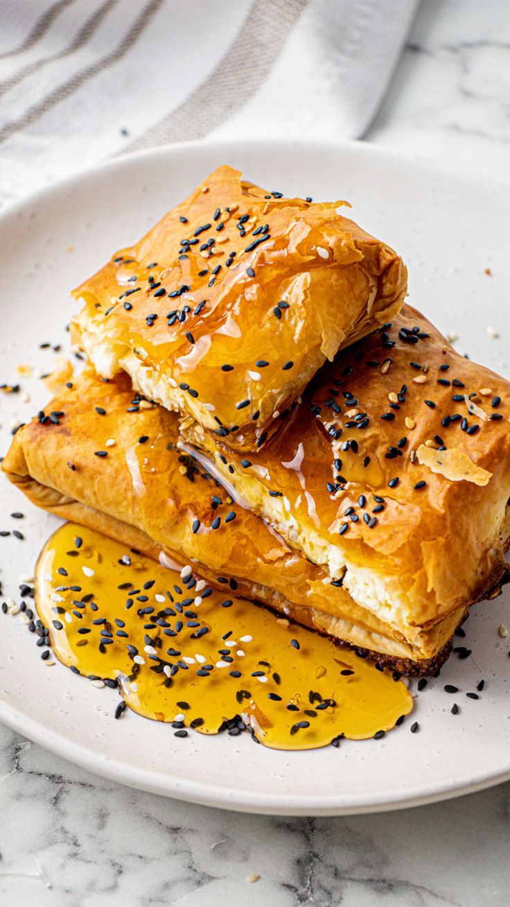 two pieces of pastry on a plate with mustard