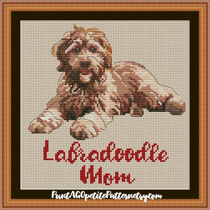 a cross stitch pattern with a dog laying down on it's side and the words la