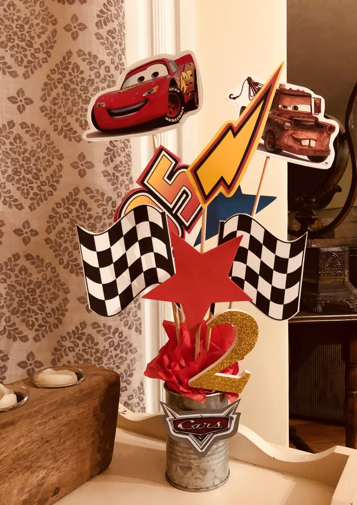 a vase filled with cars on top of a table