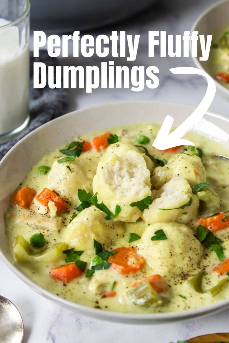 two white bowls filled with dumplings next to a glass of milk