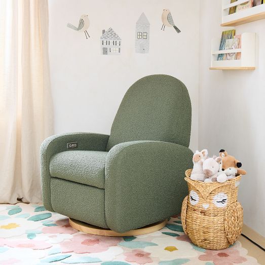 a child's room with a rocking chair, stuffed animals and a basket on the floor