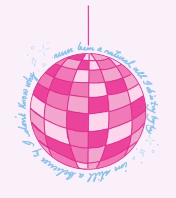 a pink and white christmas ornament hanging from a string