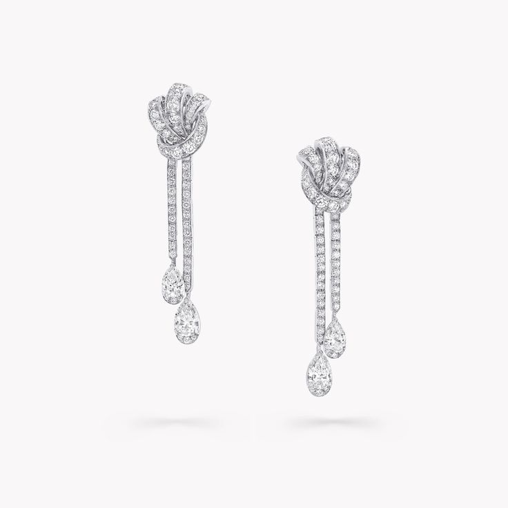 Pavé diamonds trace the contours of this petite yet powerful symbol of love in our Tilda’s Bow stud earrings. The white gold is sculpted by our master craftspeople to form a strong and graphic knot motif, tightly bound for unerring devotion. The Tilda’s Bow collection includes delicate pendants presented upon sleek chains, stud earrings and diamond rings, accompanied by larger high jewellery pieces that flaunt pear shape diamond drops. An exquisite pair of Tilda’s Bow pavé diamond earrings with Graff Jewelry, Diamond Drop Pendant, Classic Diamond Ring, Pear Shaped Diamond Ring, Diamond Drop Necklace, Pave Diamond Earrings, High Jewellery, Platinum Jewelry, Bow Jewelry