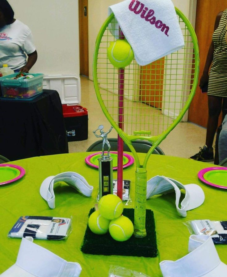 a tennis racket and balls on a table